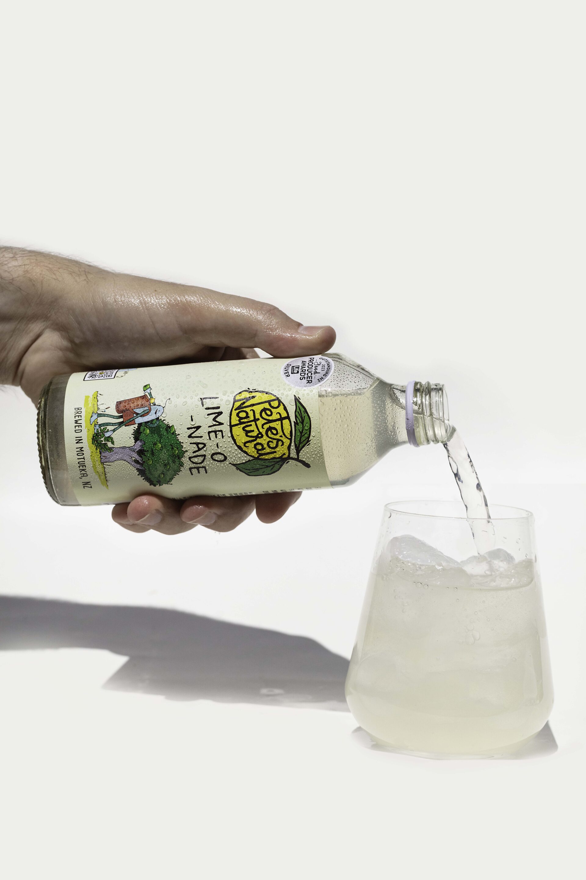 Lime soda poured into a glass with ice