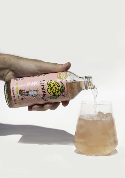 Pink Lemonade soda poured into a glass of ice